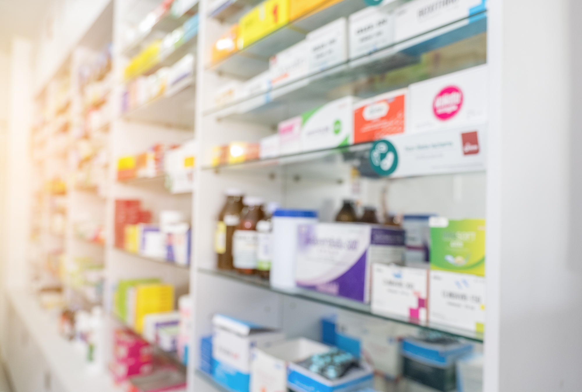 Blurry view of drug store and pharmacist.