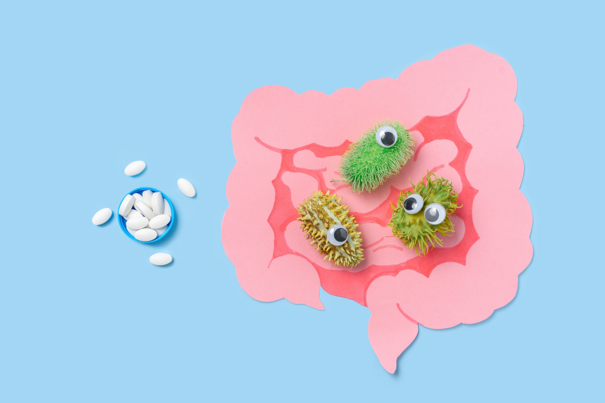 Cartoon Intestines With Bacteria And Medicine Pills