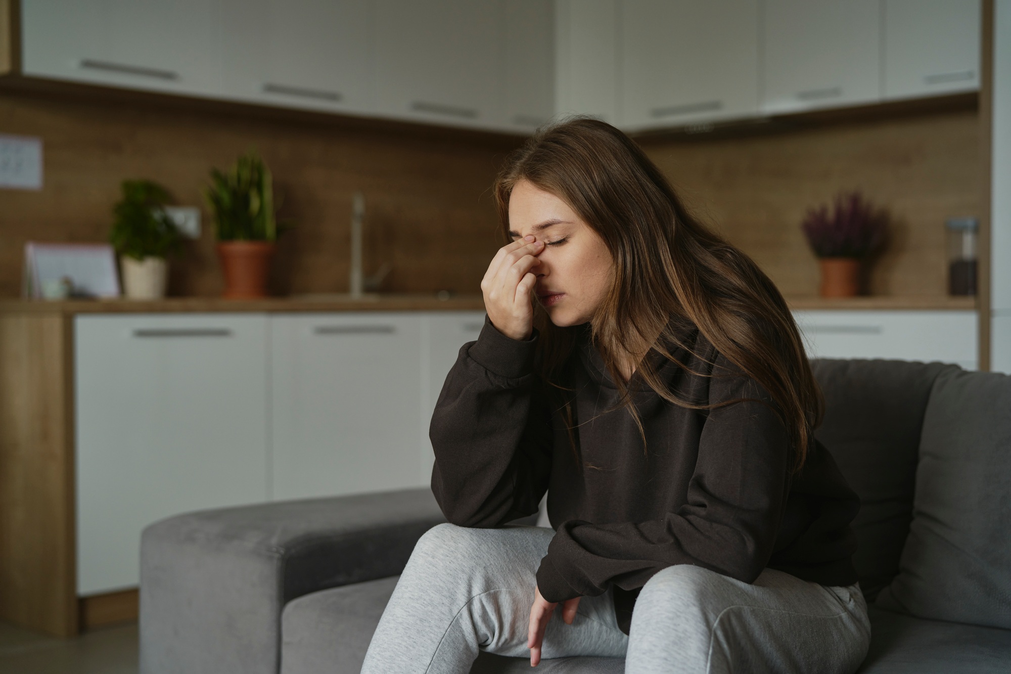 Caucasian woman with pain of nasal sinus at home